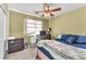 Bedroom with neutral walls, a dark wood dresser, and a window for natural light at 2526 Begonia Valley Ave, Henderson, NV 89074