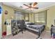 Bedroom featuring a neutral color scheme, a ceiling fan, and a dedicated workspace at 2526 Begonia Valley Ave, Henderson, NV 89074