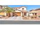 Charming two-story home featuring desert landscaping and a well-maintained lawn at 2526 Begonia Valley Ave, Henderson, NV 89074