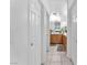 Hallway view towards a bathroom, showing vanity with wooden cabinets at 2526 Begonia Valley Ave, Henderson, NV 89074