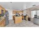 Well-lit kitchen features stainless steel appliances, a central island, and tile floors at 2526 Begonia Valley Ave, Henderson, NV 89074