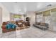 Cozy living room with neutral walls, tile floors, and comfortable seating at 2526 Begonia Valley Ave, Henderson, NV 89074