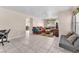 Spacious living room with tile floors, comfortable seating, and a view into the dining area at 2526 Begonia Valley Ave, Henderson, NV 89074