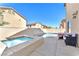 Backyard featuring a pool, jacuzzi, patio furniture, and a privacy fence at 2526 Begonia Valley Ave, Henderson, NV 89074