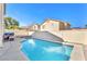 Backyard oasis with a large pool, jacuzzi, cascading waterfall, and patio furniture at 2526 Begonia Valley Ave, Henderson, NV 89074