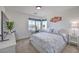 Comfortable bedroom with a large window, white furniture, and stylish decor at 2641 Via Monet, Henderson, NV 89044