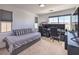 Bedroom with a full size bed, multiple monitors on the desk, and big windows at 2641 Via Monet, Henderson, NV 89044