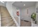 Bright foyer featuring staircase with carpet steps, tiled floors, and a white door at 2641 Via Monet, Henderson, NV 89044