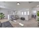 Spacious living room with recessed lights, plants, futon, chairs, and a washer and dryer at 2641 Via Monet, Henderson, NV 89044