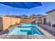 Backyard featuring a pool and spa combination with a view of neighboring houses under a blue sky at 2641 Via Monet, Henderson, NV 89044