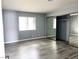 Bedroom featuring a mirrored closet, a window with blinds and grey wood floors at 2720 Beaver Creek Ct # 202, Las Vegas, NV 89117