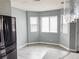 Dining area featuring 3 windows with blinds, gray walls and light gray wood floors at 2720 Beaver Creek Ct # 202, Las Vegas, NV 89117