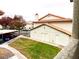 Exterior view of a home featuring a red tile roof, well-maintained lawn, and covered parking area at 2720 Beaver Creek Ct # 202, Las Vegas, NV 89117