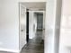 Hallway showing bedroom doorways, light gray walls and light gray wood floors at 2720 Beaver Creek Ct # 202, Las Vegas, NV 89117