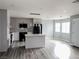 Kitchen island open floor plan featuring stainless steel appliances and light gray wood floors at 2720 Beaver Creek Ct # 202, Las Vegas, NV 89117