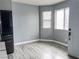 Living area with natural light, gray wood floors and stainless steel refrigerator at 2720 Beaver Creek Ct # 202, Las Vegas, NV 89117