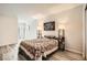 Neutral bedroom with decorative quilt, side tables, and a wall print above the bed at 275 N Lamb Blvd # E, Las Vegas, NV 89110