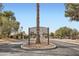 Welcoming entrance to Crossroads III, featuring lush greenery and a community sign at 275 N Lamb Blvd # E, Las Vegas, NV 89110