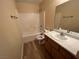 Bathroom featuring a single sink vanity, a mirror, and a bathtub/shower combination, providing essential amenities and functionality at 3118 Honeysuckle Ave, North Las Vegas, NV 89031