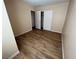 A standard bedroom featuring laminate flooring, a double door closet, and neutral paint to create a cozy retreat at 3118 Honeysuckle Ave, North Las Vegas, NV 89031