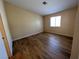 Cozy bedroom features plank floors, neutral paint, and a bright window at 3118 Honeysuckle Ave, North Las Vegas, NV 89031