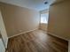 Bedroom features plank floors, neutral paint, and a window at 3118 Honeysuckle Ave, North Las Vegas, NV 89031