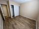 The bedroom features laminate flooring, a closet with sliding doors, and is painted a neutral color providing a blank canvas at 3118 Honeysuckle Ave, North Las Vegas, NV 89031