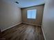 The bedroom features wood-look laminate flooring and a window offering natural light, creating a simple and functional space at 3118 Honeysuckle Ave, North Las Vegas, NV 89031