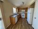 The kitchen includes wood cabinets, white appliances, plank flooring, and natural light at 3118 Honeysuckle Ave, North Las Vegas, NV 89031