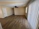 Open-concept living room with plank floors, neutral paint, ceiling fan, and sliding glass door at 3118 Honeysuckle Ave, North Las Vegas, NV 89031