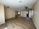 Inviting living room featuring modern wood laminate flooring and an open floor plan leading to the kitchen at 3118 Honeysuckle Ave, North Las Vegas, NV 89031