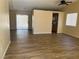 Spacious open-concept living room featuring modern wood laminate flooring and sliding glass doors to the backyard at 3118 Honeysuckle Ave, North Las Vegas, NV 89031