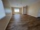 Open-concept living room featuring plank floors, neutral paint, and ample natural light at 3118 Honeysuckle Ave, North Las Vegas, NV 89031