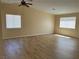 Bright and airy living room featuring modern wood laminate flooring and neutral-colored walls at 3118 Honeysuckle Ave, North Las Vegas, NV 89031