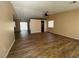 Expansive living room with wood laminate floors, open layout, and seamless flow to the outdoor patio at 3118 Honeysuckle Ave, North Las Vegas, NV 89031