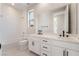 Bright bathroom featuring double sinks with black hardware, white cabinets, tile flooring, and a shower-tub combo at 350 Robledo St, Las Vegas, NV 89138