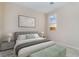 Relaxing bedroom featuring a queen bed, neutral decor, and ample natural light from a large window at 350 Robledo St, Las Vegas, NV 89138