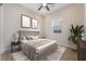 Bright bedroom featuring a queen bed, a ceiling fan, and large windows for natural light at 350 Robledo St, Las Vegas, NV 89138