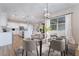 Bright dining area open to kitchen featuring modern lighting and backyard views at 350 Robledo St, Las Vegas, NV 89138