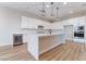 Modern kitchen features a large island, stainless steel appliances, and sleek white cabinets at 350 Robledo St, Las Vegas, NV 89138