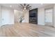 Spacious living room featuring a fireplace, a flat-screen TV, light wood floors, and modern decor at 350 Robledo St, Las Vegas, NV 89138