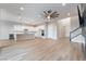 Open living space with light wooden floors, white walls, a gourmet kitchen, and modern lighting at 350 Robledo St, Las Vegas, NV 89138