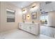 Elegant main bathroom featuring double sinks, modern fixtures, and a spacious layout at 350 Robledo St, Las Vegas, NV 89138