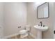 Elegant powder room with tile floors, a pedestal sink with a black faucet, and a black framed mirror at 350 Robledo St, Las Vegas, NV 89138