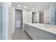 Bright bathroom featuring a double vanity, walk-in closet, and designer black and white geometric tile flooring at 353 E Bonneville Ave # 1407, Las Vegas, NV 89101