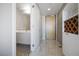 Hallway featuring modern finishes, tile floors, and access to bathroom at 353 E Bonneville Ave # 1407, Las Vegas, NV 89101