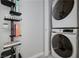 Modern laundry room with stacked washer and dryer and book shelving at 353 E Bonneville Ave # 1407, Las Vegas, NV 89101