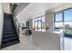 Modern kitchen with a large island and an adjacent dining area, stairs leading to the upper floor at 353 E Bonneville Ave # 1407, Las Vegas, NV 89101