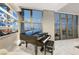 Living room corner featuring a grand piano and comfortable seating, bathed in natural light from the large windows at 353 E Bonneville Ave # 1407, Las Vegas, NV 89101