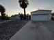 Single-story home with detached garage and desert landscaping at 3647 Ottawa Cir, Las Vegas, NV 89169